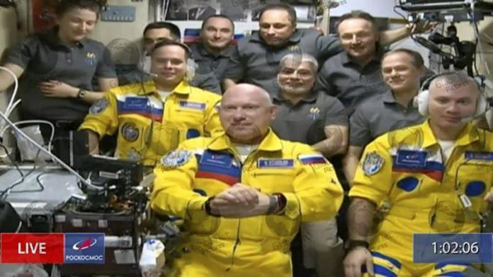 RUSSIAN COSMONAUTS BOARD SPACE STATION IN YELLOW AND BLUE SUITS IN SHOW OF SUPPORT FOR UKRAINE